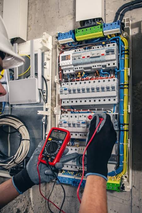 Electrician inspecting a residential electrical panel